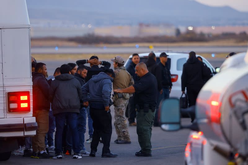 Migrants, transferred from Plattsburgh, New York to El Paso, Texas, disembark from a plane at the airport, in El Paso