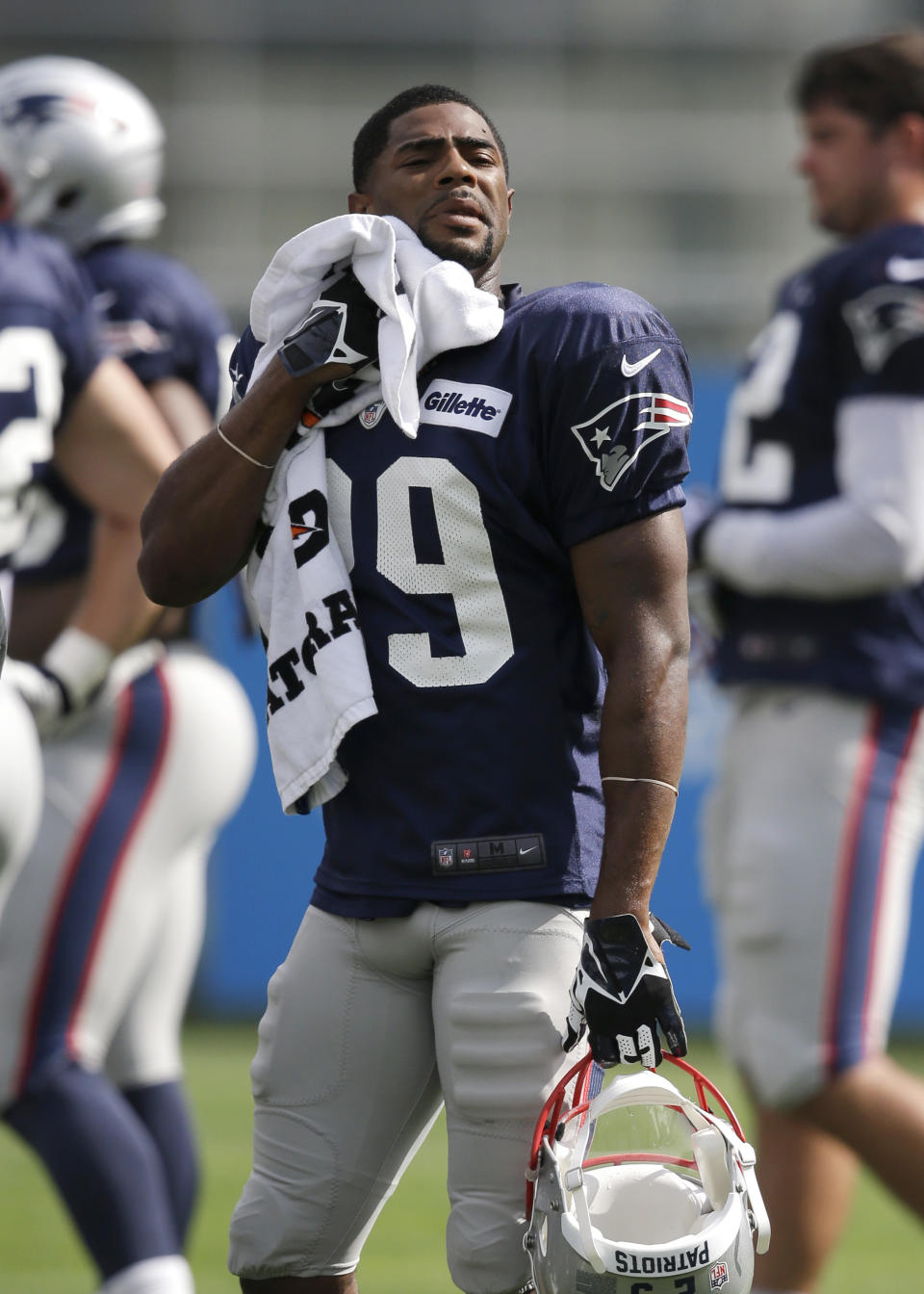 FILE - New England Patriots defensive back Malcolm Butler wipes his face with a towel during an NFL football training camp practice at Gillette Stadium, Sunday, July 27, 2014, in Foxborough, Mass. Butler was an "invited tryout" player who got his chance in May of that year. The coronavirus pandemic scuttled most college pro days, wiped out all rookie minicamps and obliterated the NFL's traditional offseason, making it became almost impossible for long shots to make their mark and, consequently, the 53-man roster. (AP Photo/Steven Senne, File)