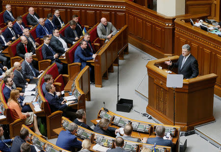 Ukrainian President Petro Poroshenko addresses lawmakers before a voting on his appeal to Ecumenical Patriarch Bartholomew to create a unified Ukrainian Orthodox church free from the influence of Russia, during a parliamentary session in Kiev, Ukraine April 19, 2018. REUTERS/Valentyn Ogirenko