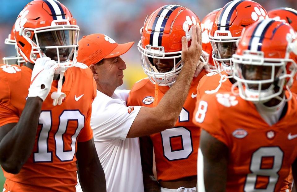 Clemson Tigers head coach Dabo Swinney, center, speaks to wide receiver E.J. Williams, right, during the teamÕs warm up prior to action against the Georgia Bulldogs at Bank of America Stadium in Charlotte, NC on Saturday, September 4, 2021. The Clemson Tigers and Georgia Bulldogs are battling in the DukeÕs Mayo Classic.