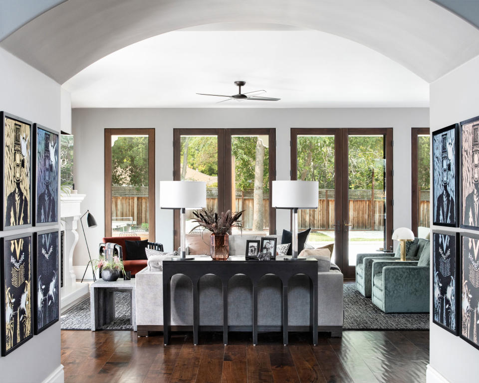 Open-plan living room, view from entryway, social seating setup, large floor to ceiling windows