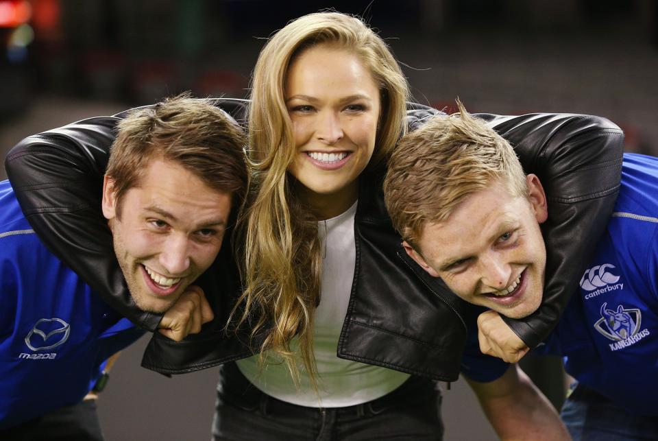 <p>Rousey takes on Kangaroos AFL players Jamie Macmillan (L) and Jack Ziebell (R) as part of her promotional tour ahead of UFC 193 in Melbourne.</p>