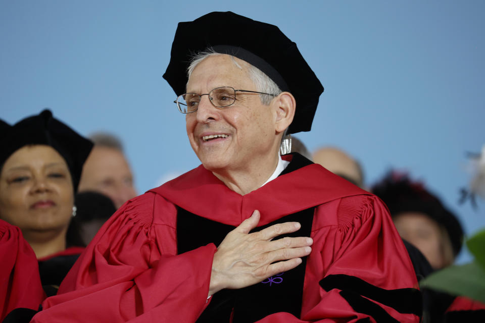Attorney General Merrick Garland reacts as he is introduced before speaking at a Harvard Commencement ceremony held for the classes of 2020 and 2021, Sunday, May 29, 2022, in Cambridge, Mass. (AP Photo/Mary Schwalm)