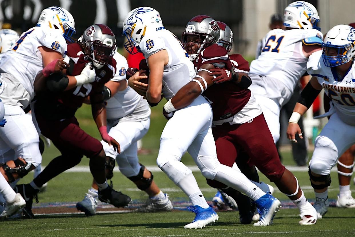 Missouri State defenders attempt to tackle South Dakota State quarterback Mark Gronowski on Sept. 24, 2022, in Springfield, Missouri.