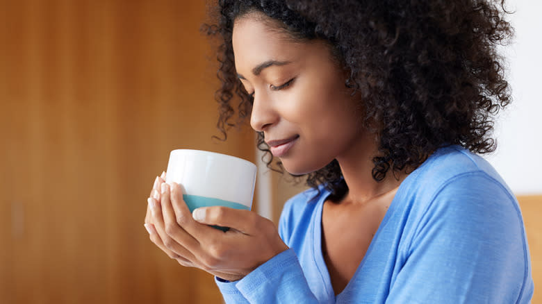 woman enjoying cup of coffee