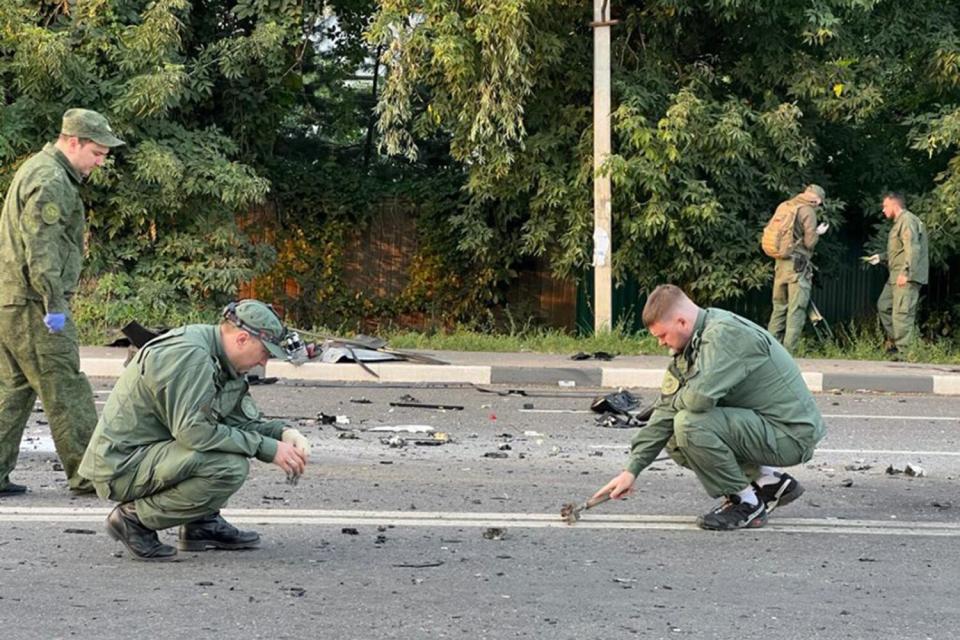A handout photo made available on 21 August 2022 by the Russian Investigative Committee shows investigators working at the scene of a car explosion on Mozhaisk highway near the village of Bolshiye Vyazemi in the Odintsovo urban district in Moscow region, Russia. In the evening of 20 August a Toyota Land Cruiser car blew up when the car was moving at full speed on a highway, and then burned. The driver, journalist and political scientist Darya Dugina, the daughter of the philosopher Alexander Dugin, died on the spot. According to Russian Investigative Committee, an explosive device was allegedly installed in the car.