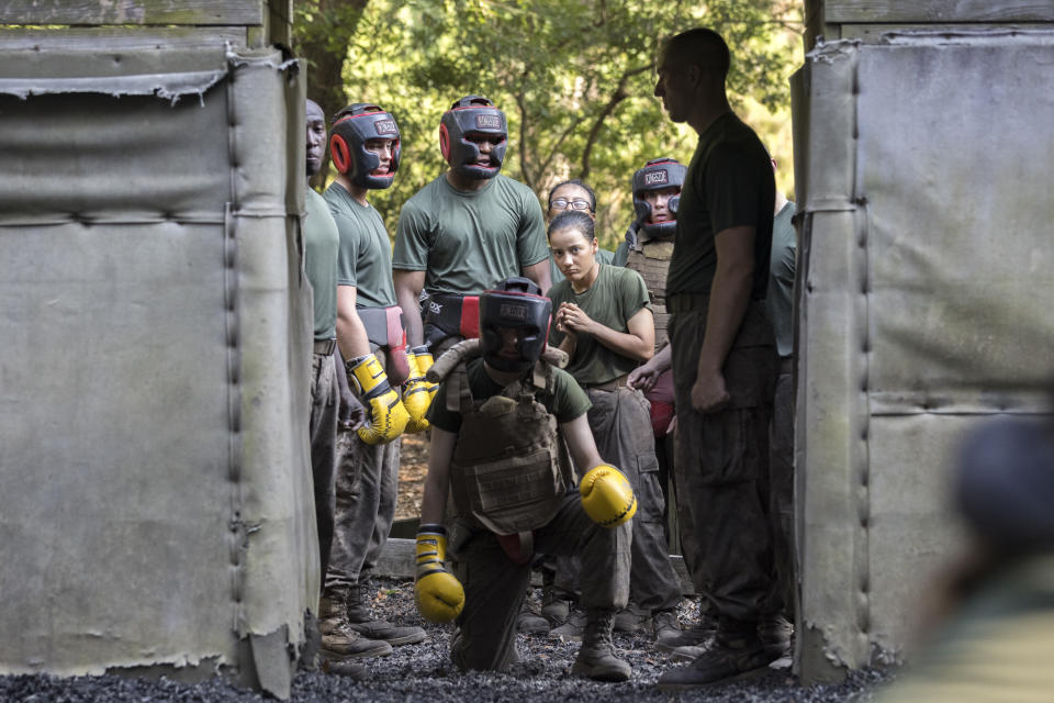 Three female U.S. Marine Corps recruits stand behind a fourth female recruit, kneeling, during a hand-to-hand combat drill in a portion of training known as the Crucible at the Marine Corps Recruit Depot, Thursday, June 29, 2023, in Parris Island, S.C. (AP Photo/Stephen B. Morton)