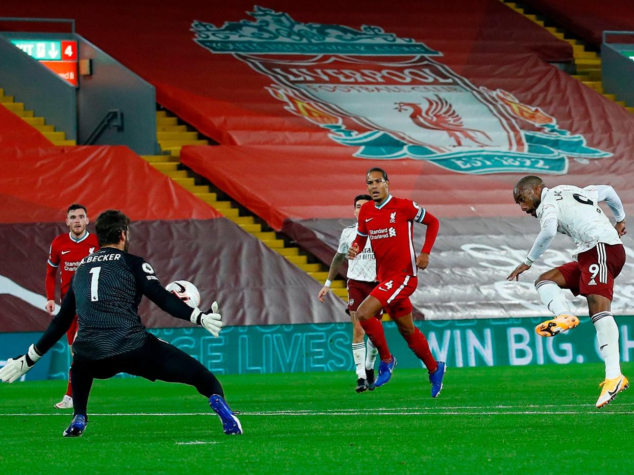 Alisson Becker saves from Alexandre Lacazette (POOL/AFP via Getty Images)