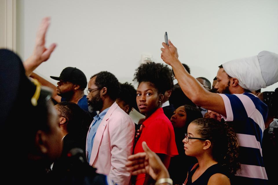 People wait in line to enter a hearing on reparations for slavery in Washington. 