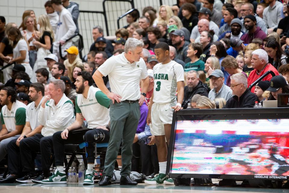 Basha Bears head coach Mike Grothaus speaks with Mason Magee (3) during a basketball match against the Perry Pumas at Basha High School on Jan. 16, 2023, in Chandler.