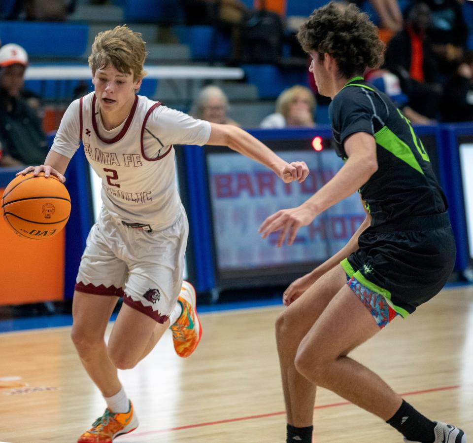 Santa Fe Catholic's Tate Darner drives to the basket against Windermere on Saturday at the Mosaic Stinger Classic.