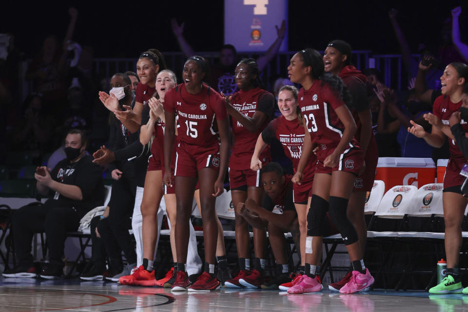 In this photo provided by Bahamas Visual Services, the South Carolina bench, including Laeticia Amihere (15) and Bree Hall (23) reacts during an NCAA college basketball game at Paradise Island, Bahamas, Monday, Nov. 22, 2021. (Tim Aylen/Bahamas Visual Services via AP)