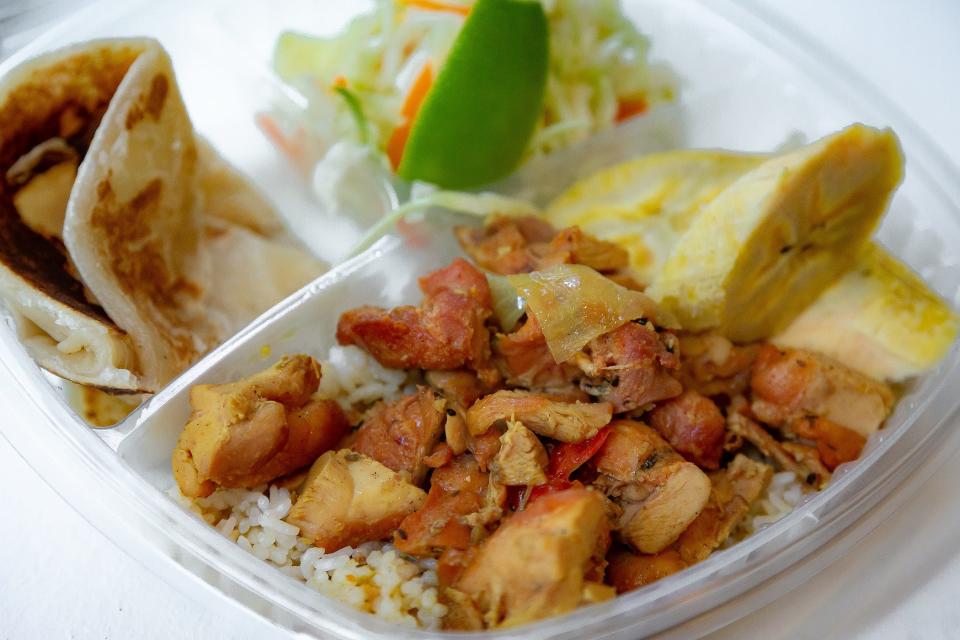 Smoked Curry Chicken with roti, slaw and roasted plantains is served at the new Tropical BBQ Market.