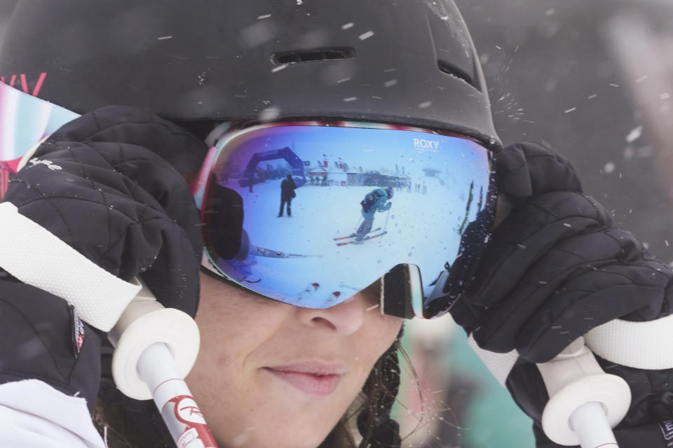 A tourist prepares as she arrives at Plan de Corones ski area, Italy South Tyrol, Saturday, Nov. 27, 2021. After nearly two years of being restricted to watching snow accumulate on distant mountains, Italian skiers are finally returning to the slopes that have been off limits since the first pandemic lockdown in March 2020. But just as the industry is poised to recover from a lost 2020-2021 season after an abrupt closure the previous year, a spike in cases in the Alpine province bordering Austria is underlining just how precarious the situation remains. (AP Photo/Luca Bruno)