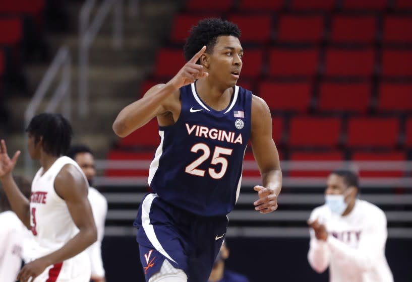 Virginia's Trey Murphy III (25) heads back down court after scoring during the second half of Virginia's 64-57 victory over North Carolina State in an NCAA college basketball game Wednesday, Feb. 3, 2021, in Raleigh, N.C. (Ethan Hyman/The News & Observer via AP, Pool)