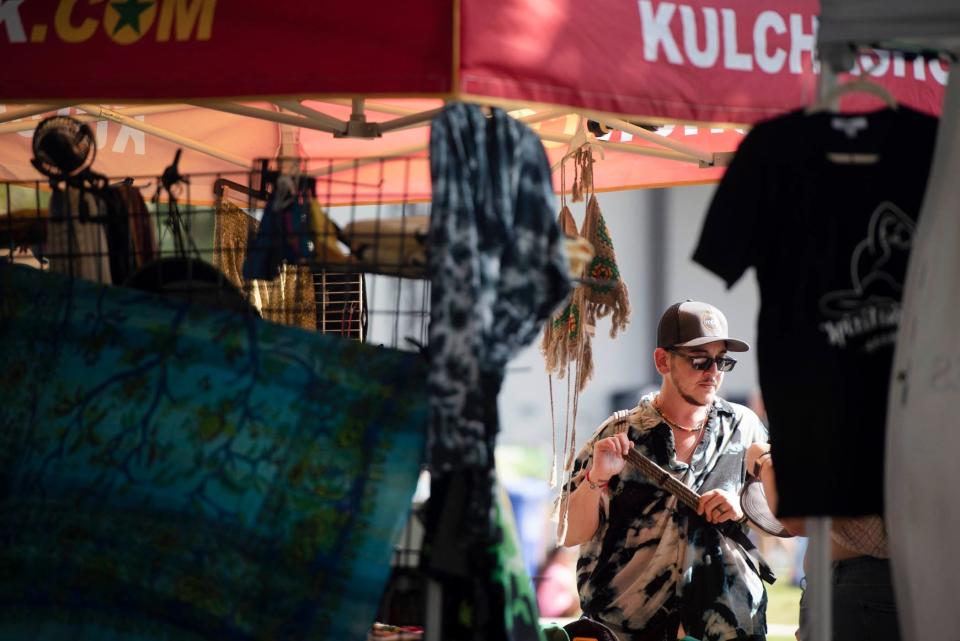 Channing Koury, of Port St. Lucie, shops during Reggae Fest FL at Boynton Beach Amphitheater at Centennial Park Saturday November 12, 2022 in Boyton Beach. 