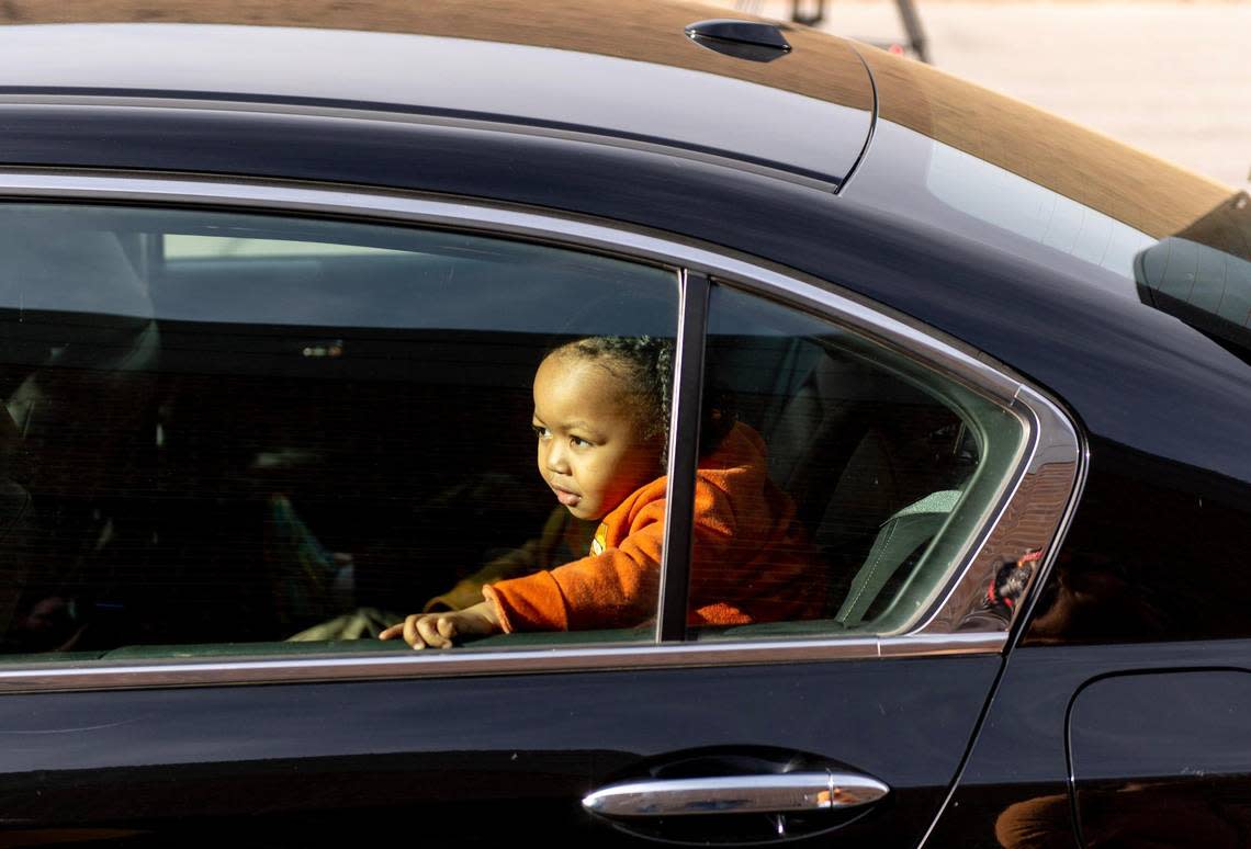 Two-year-old Jeremiah Russell explores a car donated to his mother, Tyisha, from the Urban League of Greater Kansas City on Wednesday, Jan. 11, 2023, in Kansas City.