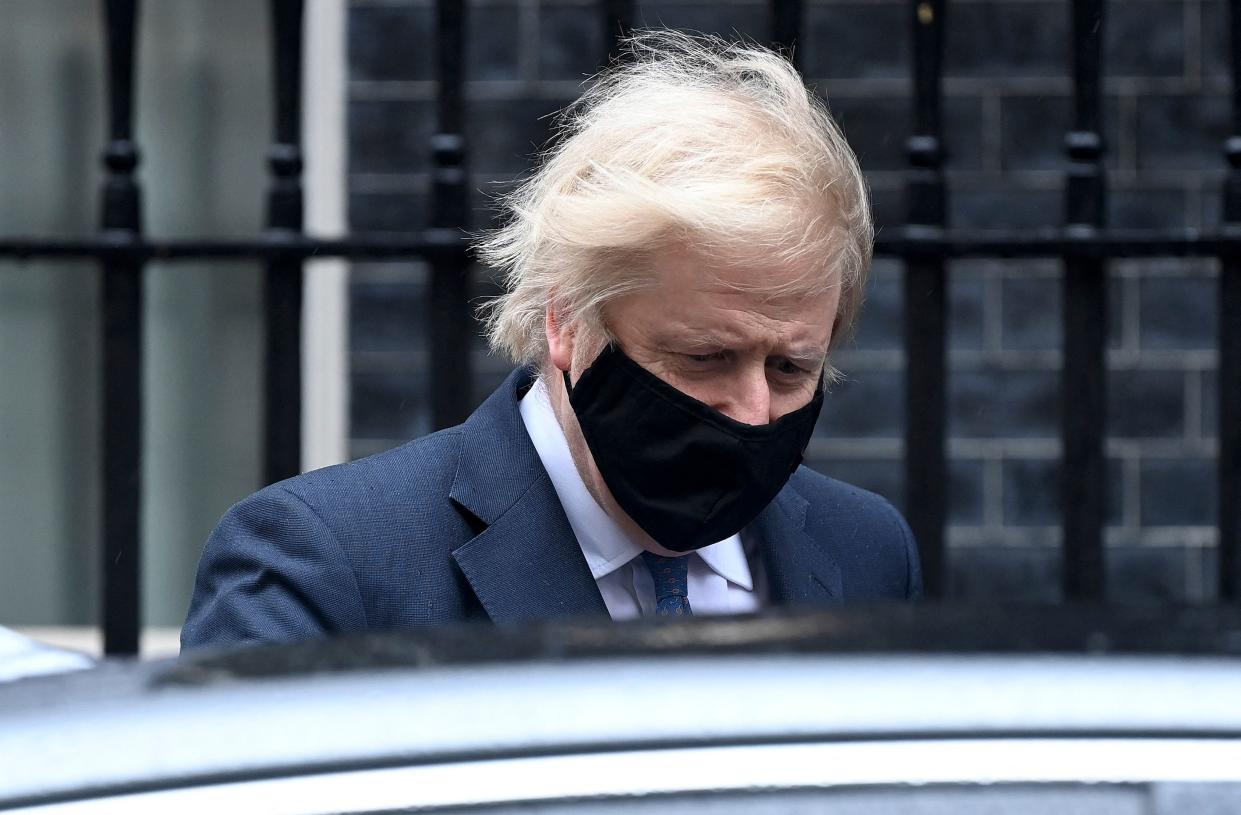 Britain's Prime Minister Boris Johnson, wearing a protective face covering to combat the spread of the coronavirus, leaves 10 Downing Street in central London on March 10, 2021, to take part in the weekly session of Prime Minister's Questions (PMQs) at the House of Commons. (Photo by - / AFP) (Photo by -/AFP via Getty Images)