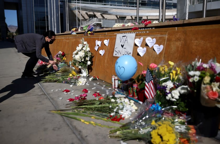 SAN JOSE, CALIFORNIA - MAY 27: A mourner leaves flowers at a memorial for the nine victims of a shooting at the Santa Clara Valley Transportation Authority (VTA) light rail yard on May 27, 2021 in San Jose, California. Nine people were killed when a VTA employee opened fire at the VTA light rail yard during a shift change on Wednesday morning. (Photo by Justin Sullivan/Getty Images)