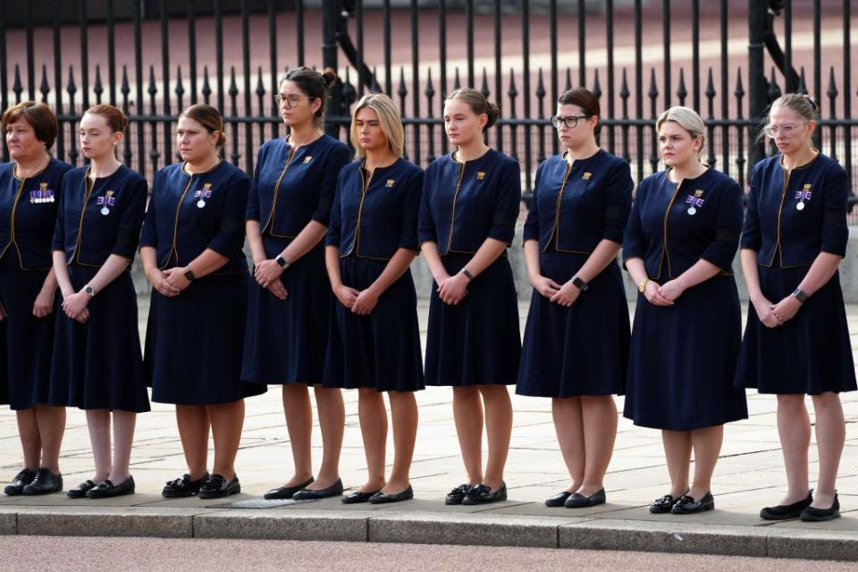 Buckingham Palace staff line up during Queen Elizabeth's funeral procession