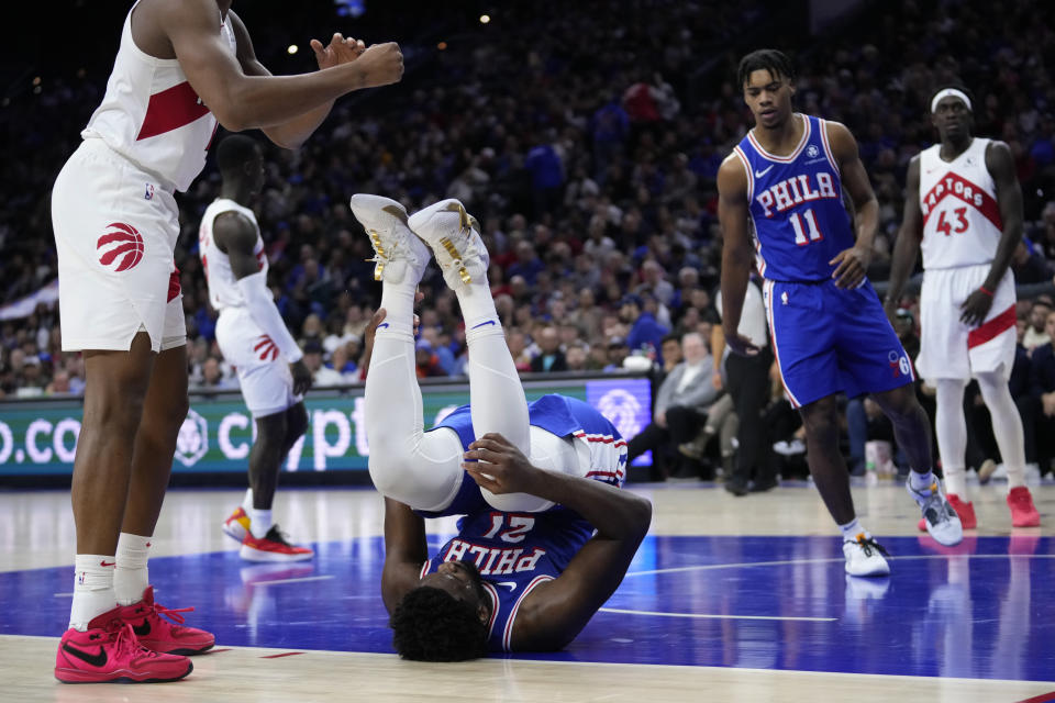 Philadelphia 76ers' Joel Embiid tumbles after being fouled during the first half of an NBA basketball game against the Toronto Raptors, Thursday, Nov. 2, 2023, in Philadelphia. (AP Photo/Matt Slocum)