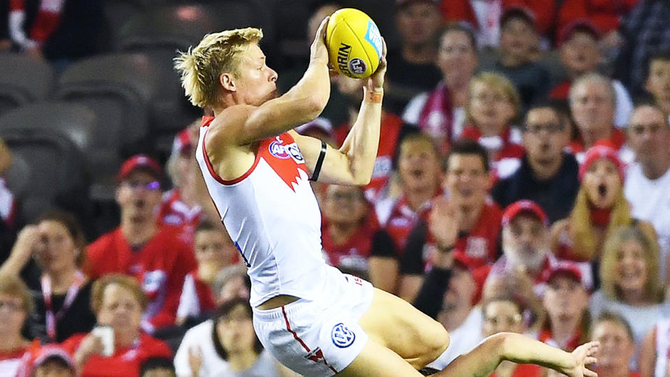 Isaac Heeney soars over the Bulldogs. (Photo by Quinn Rooney/Getty Images)