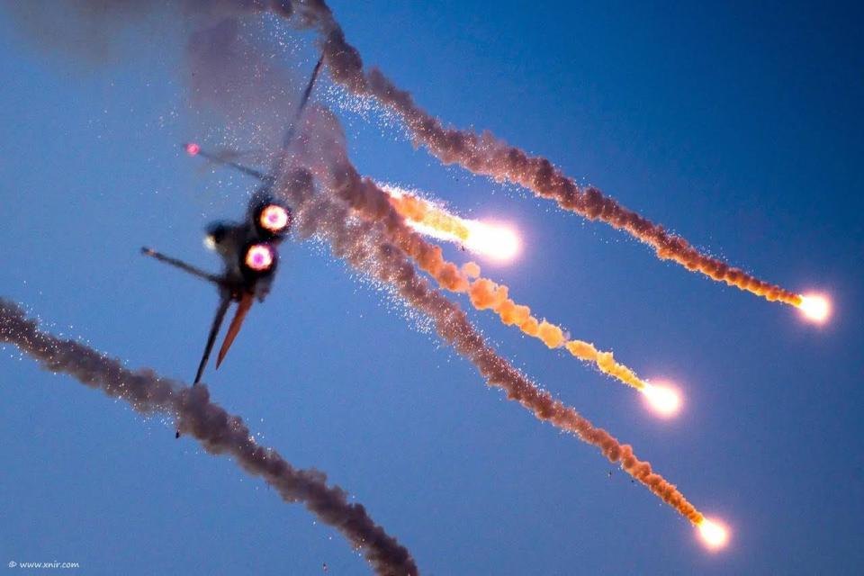 The F-15I fighter jet firing flares