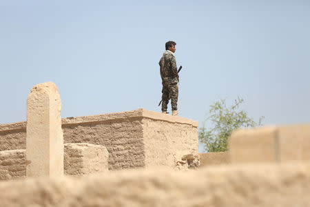 A pro-government soldier stands guard at a historical site in the northern city of Marib, Yemen November 3, 2017. REUTERS/Ali Owidha