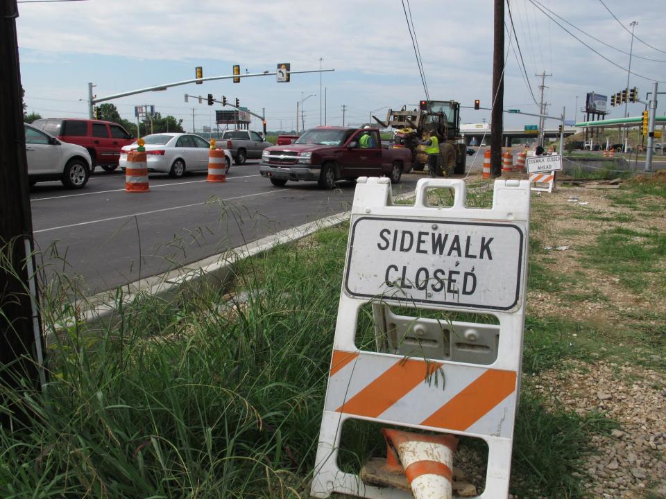 A "sidewalk closed" sign marks the spot where workers are making improvements to Elvis Presley Blvd. on Tuesday, Aug. 6, 2013 in Memphis, Tenn. The boulevard, which runs right in front of Graceland, Presley's longtime Memphis home, is undergoing a $43 million infrastructure improvement project that officials hope will please tourists and improve the quality of life of the residents of the Whitehaven community. (AP Photo/Adrian Sainz)