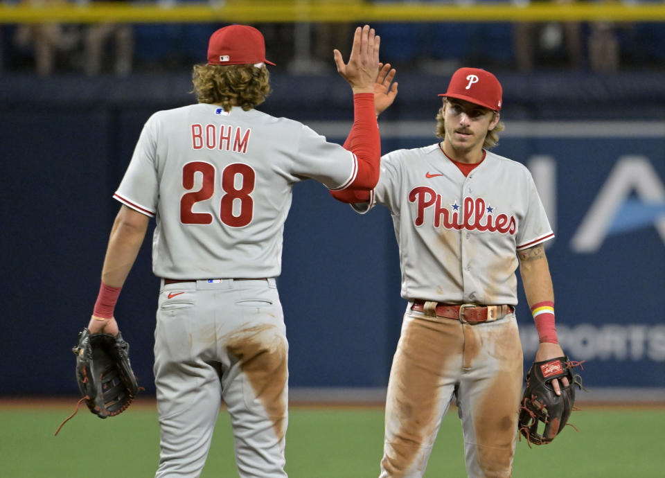 Philadelphia Phillies Alec Bohm (28) and Bryson Stott celebrate an 8-4 win over the Tampa Bay Rays on Wednesday in St. Petersburg, Florida. (AP Photo/Steve Nesius)