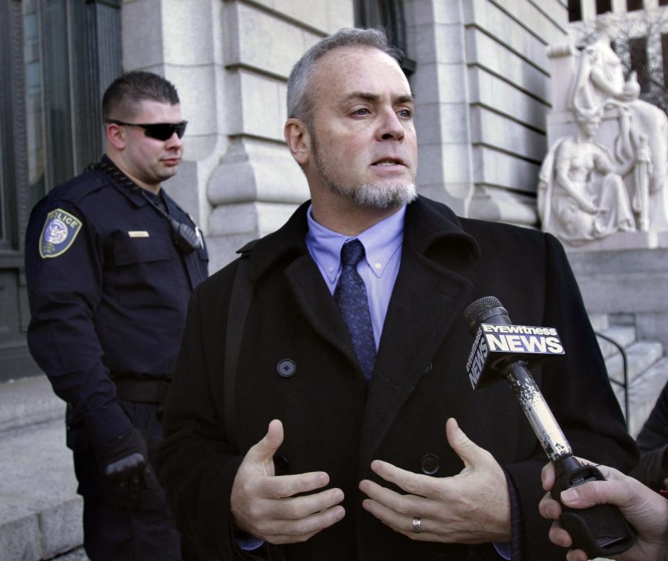 Reality TV star Richard Hatch, center, departs federal court in Providence, in January 2011.