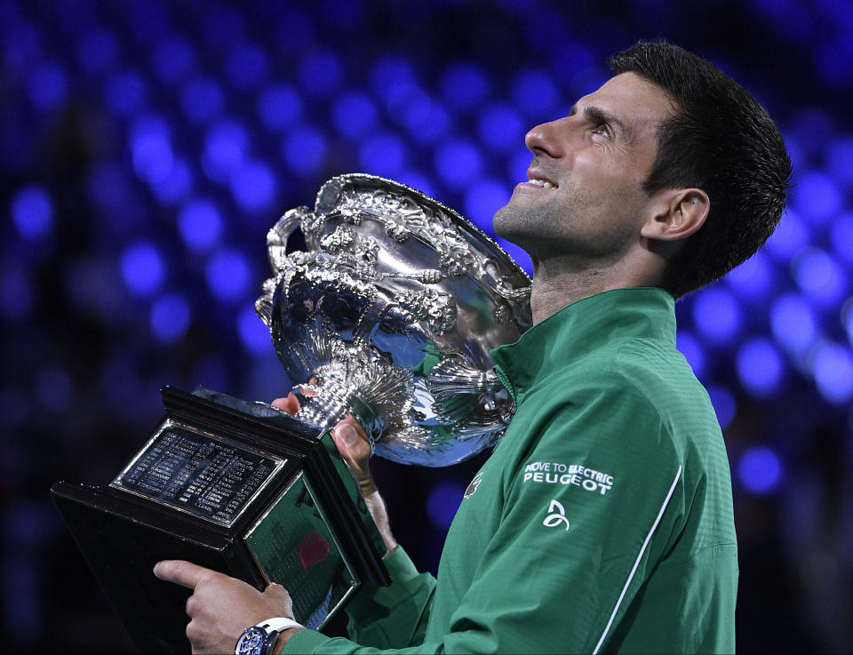 FILE - In this Feb. 3, 2020, file photo, Serbia's Novak Djokovic holds the Norman Brookes Challenge Cup after defeating Austria's Dominic Thiem in the final of the Australian Open tennis championship in Melbourne, Australia. (AP Photo/Andy Brownbill, File)