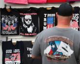 A man looks at T-shirts a day before U.S. President Donald Trump holds a rally in Tulsa