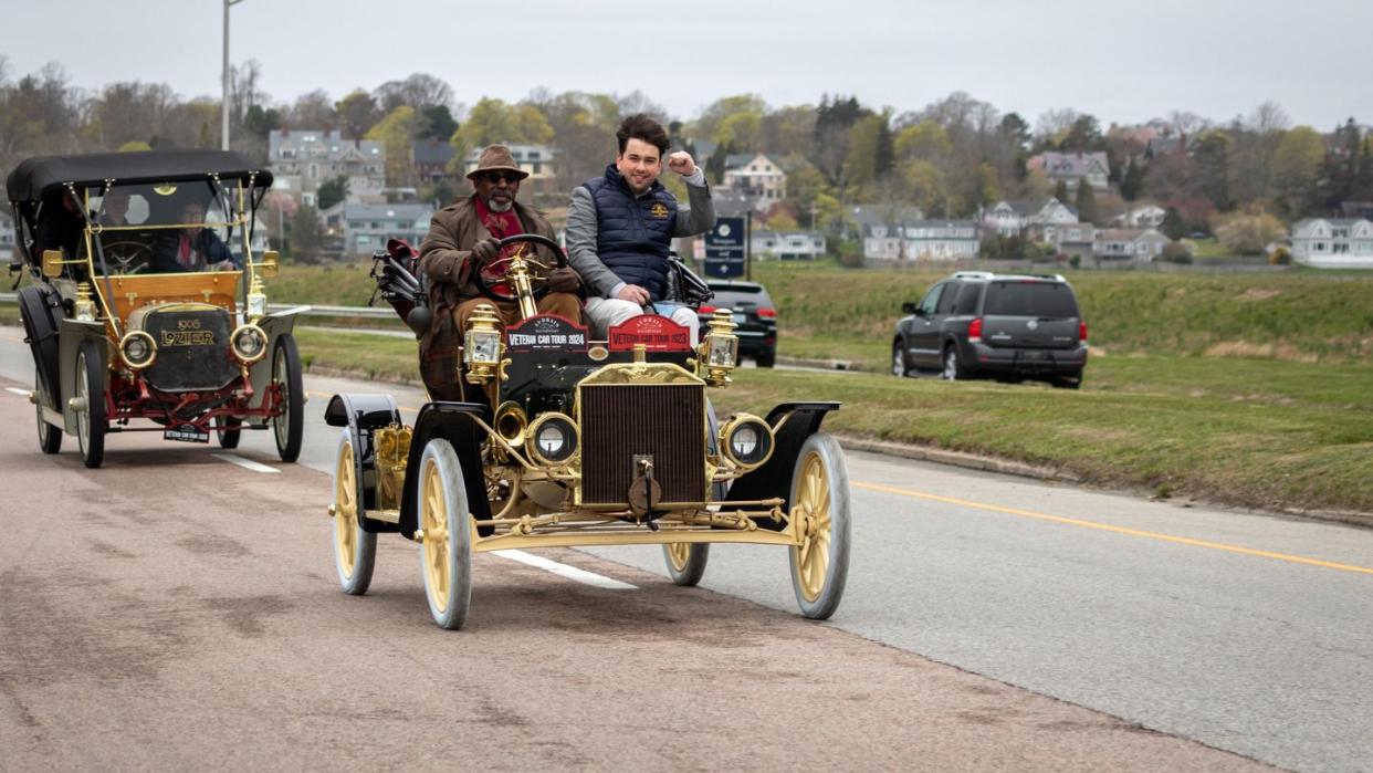 a group of people riding on an old car