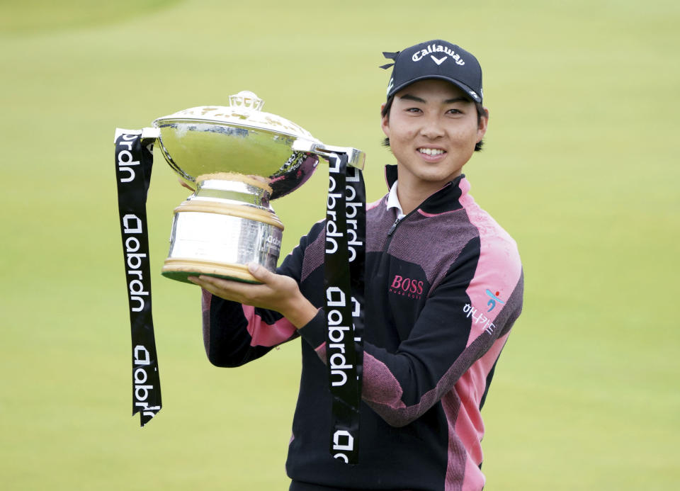 Australia's Min Woo Lee holds the trophy after winning the Scottish Open at The Renaissance Club, North Berwick, Scotland, Sunday July 11, 2021. (Jane Barlow/PA via AP)