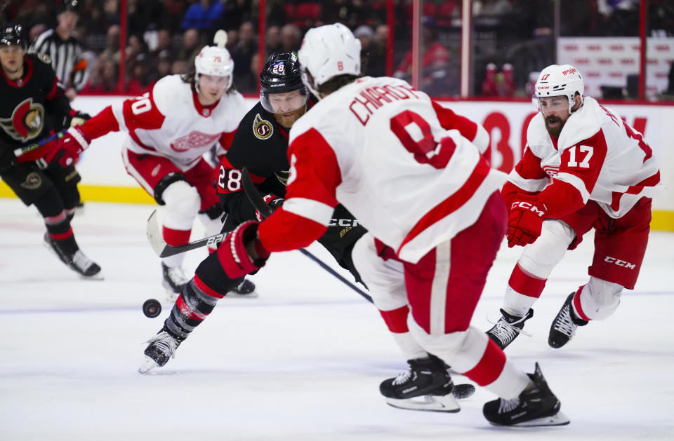 Ottawa Senators right wing Claude Giroux (28) skates the puck upice as Detroit Red Wings Ben Chiarot (8) defends during second-period NHL hockey game action in Ottawa, Ontario, Monday, Feb. 27, 2023. (Sean Kilpatrick/The Canadian Press via AP)