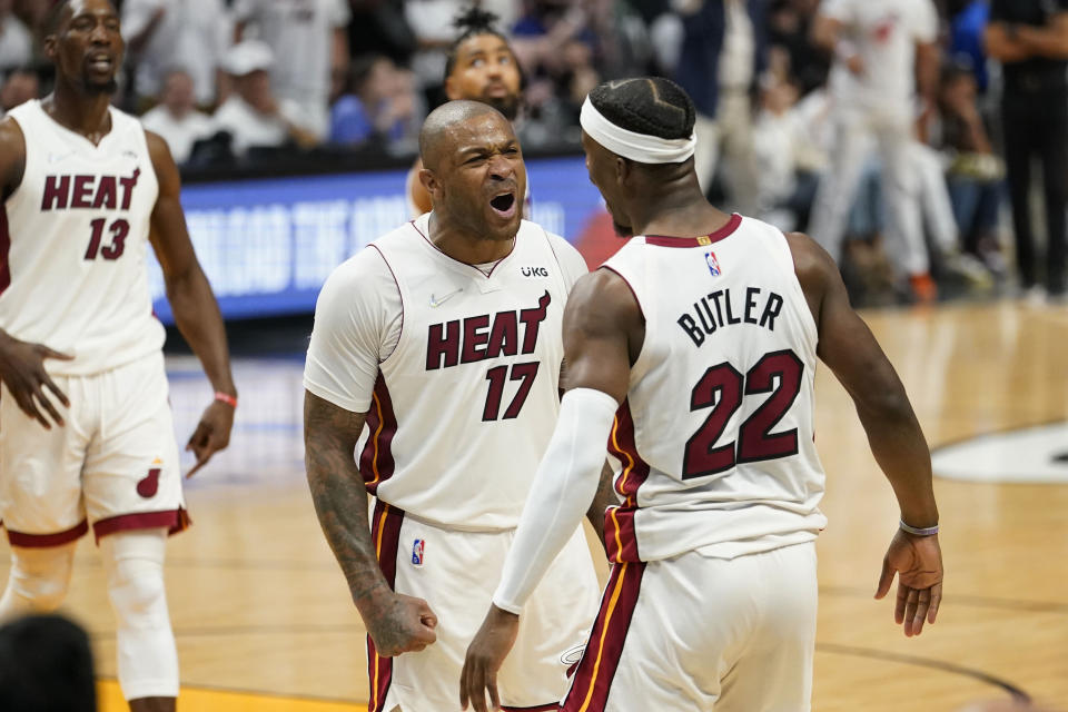 Miami Heat forward P.J. Tucker (17) and forward Jimmy Butler (22) celebrate during the second half of Game 1 of an NBA basketball Eastern Conference finals playoff series against the Boston Celtics, Tuesday, May 17, 2022, in Miami. (AP Photo/Lynne Sladky)