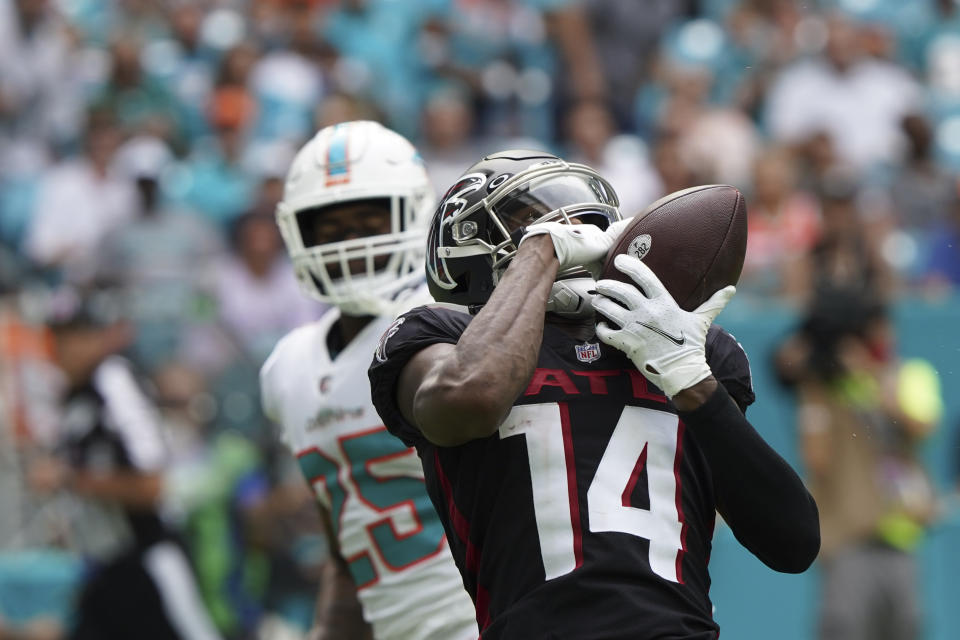 Atlanta Falcons wide receiver Russell Gage (14) makes the catch to score a touchdown as Miami Dolphins cornerback Xavien Howard (25) looks on, during the second half of an NFL football game, Sunday, Oct. 24, 2021, in Miami Gardens, Fla. (AP Photo/Hans Deryk)