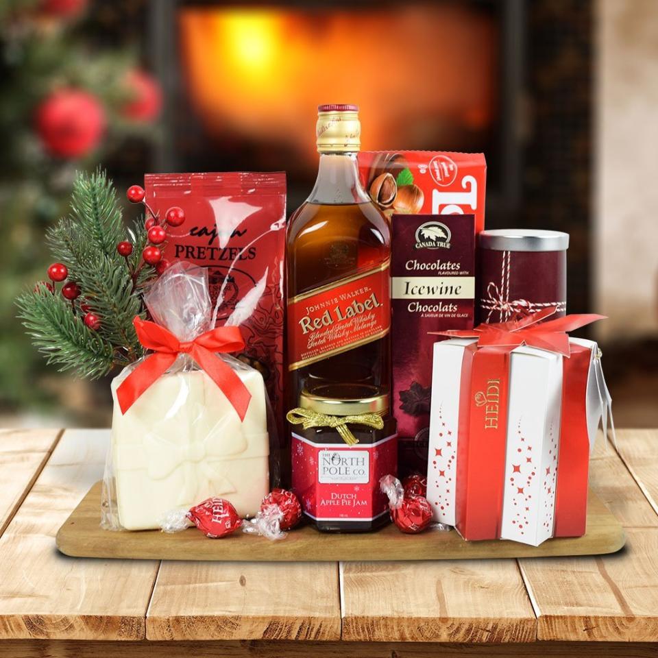 <p>Chocolate, whiskey, the colour red — does it get more holiday than this? At any rate a gift set full of treats like this is a great go-to for those men that can sometimes be difficult to buy for (but appreciates a sweet indulgence here and there). The gift set comes with a selection of chocolates, some with icewine flavour, as well as popcorn, pretzels, an apple pie jam, wafers, and of course the main attraction: Red Label whiskey. There’s also a cool serving board offered that should be put to good use over the coming weeks.<br><a rel="nofollow noopener" href="https://www.hazeltons.ca/collections/liquor-gift-baskets/products/christmas-delights-with-whiskey" target="_blank" data-ylk="slk:SHOP IT: Hazeltons, $111.99;elm:context_link;itc:0;sec:content-canvas" class="link "><strong>SHOP IT: Hazeltons, $111.99</strong></a> </p>