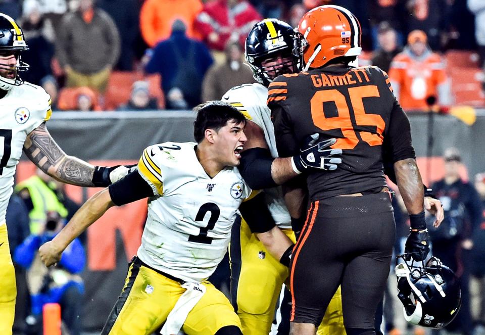 Nov 14, 2019; Cleveland, OH, USA; Cleveland Browns defensive end Myles Garrett (95) hits Pittsburgh Steelers quarterback Mason Rudolph (2) with his own helmet as offensive guard David DeCastro (66) tries to stop Garrett during the fourth quarter at FirstEnergy Stadium. Mandatory Credit: Ken Blaze-USA TODAY Sports