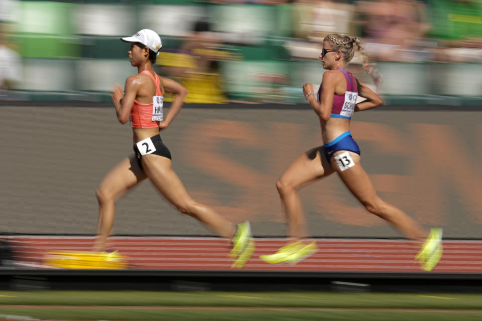 Ririka Hironaka, of Japan, and Karissa Schweizer, of the United States, compete during a heat in the women's 5000-meter run at the World Athletics Championships on Wednesday, July 20, 2022, in Eugene, Ore. (AP Photo/Charlie Riedel)