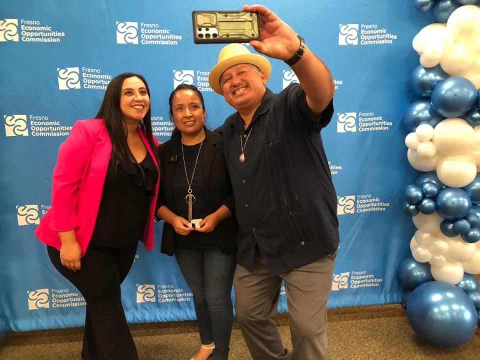 Huron City Manager Virginia Peñaloza, left, poses for a selfie with Huron resident Nancy Ramirez and Huron Mayor Rey Leon Wednesday, July 17, 2024 in Fresno. Ramirez is one of the 75 families from Huron participating in the Fresno Economic Opportunities Commission guaranteed basic income pilot.