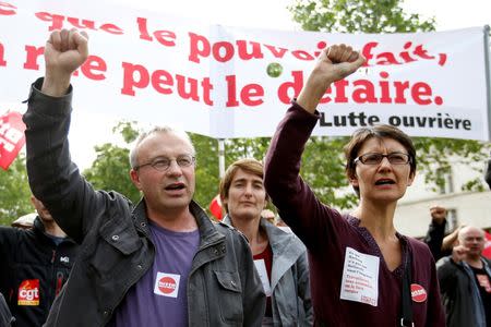 Jean-Pierre Mercier, CGT union representative (L) and Nathalie Arthaud (R), France's extreme-left Lutte Ouvriere political party (LO) leader and the party's candidate for the 2017 French presidential election march during a demonstration in protest of the government's proposed labour law reforms in Paris, France, May 26, 2016. REUTERS/Charles Platiau
