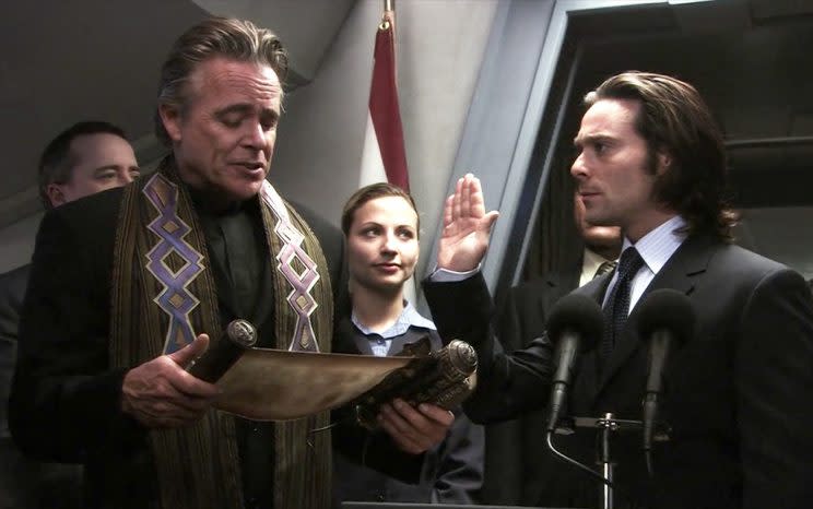 Baltar (James Callis) takes the oath of office in ‘Lay Down Your Burdens’ (Credit: NBC)