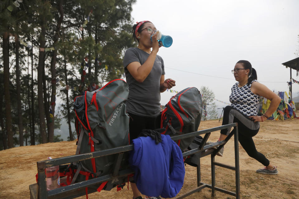 In this photo taken Saturday, March 30, 2019, Nima Doma, 34, left, and Furdiki Sherpa, 43, perform morning exercises as they train to summit Mount Everest, in Kathmandu, Nepal. Five years after one of the deadliest disasters on Mount Everest, three people from Nepal's ethnic Sherpa community, including Doma and Sherpa, are preparing an ascent to raise awareness about the Nepalese mountain guides who make it possible for hundreds of foreign climbers to scale the mountain and survive. The two women lost their husbands in the 2014 ice avalanche on Everest’s western shoulder that killed 16 fellow Sherpa guides. (AP Photo/Niranjan Shrestha)
