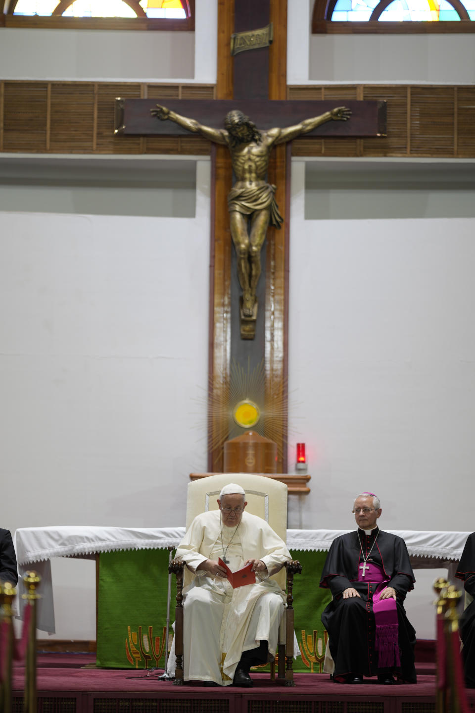 Pope Francis sits with with Pontifical Ceremonier Archbishop Diego Giovanni Ravelli inside the Saints Peter and Paul Catholic Cathedral in Ulaanbaatar, Saturday, Sept. 2, 2023, for a meeting with the local clergy. Pope Francis has praised Mongolia's tradition of religious freedom dating to the times of its founder, Genghis Khan, as he opened the first-ever papal visit to the Asian nation with a plea for peace and an end to the "insidious threat of corruption." (AP Photo/Andrew Medichini)