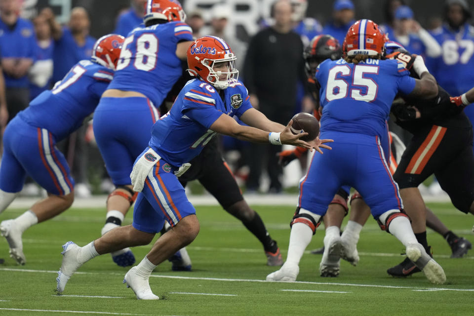 Florida quarterback Jack Miller III (10) bobbles the ball after a snap against Oregon State during the second half of the Las Vegas Bowl NCAA college football game Saturday, Dec. 17, 2022, in Las Vegas. (AP Photo/John Locher)