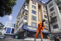 Municipality workers clean the site of explosions in Kabul, Afghanistan, Sunday, June 2, 2019. Afghan officials say there have been three explosions in the capital, Kabul, including a sticky bomb attached to a bus carrying university students. (AP Photo/Rahmat Gul)