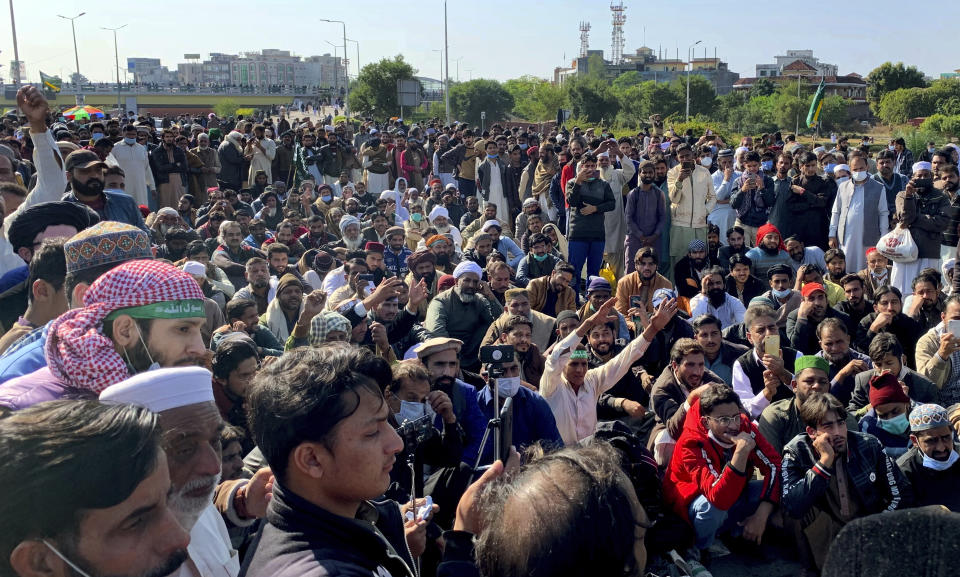 Supporters of Tehreek-e-Labaik Pakistan, a religious political party, block a main highway during an anti-France rally in Islamabad, Pakistan, Monday, Nov. 16, 2020. The supporters are protesting the French President Emmanuel Macron over his recent statements and the republishing in France of caricatures of the Muslim Prophet Muhammad they deem blasphemous. (AP Photo/Anjum Naveed)