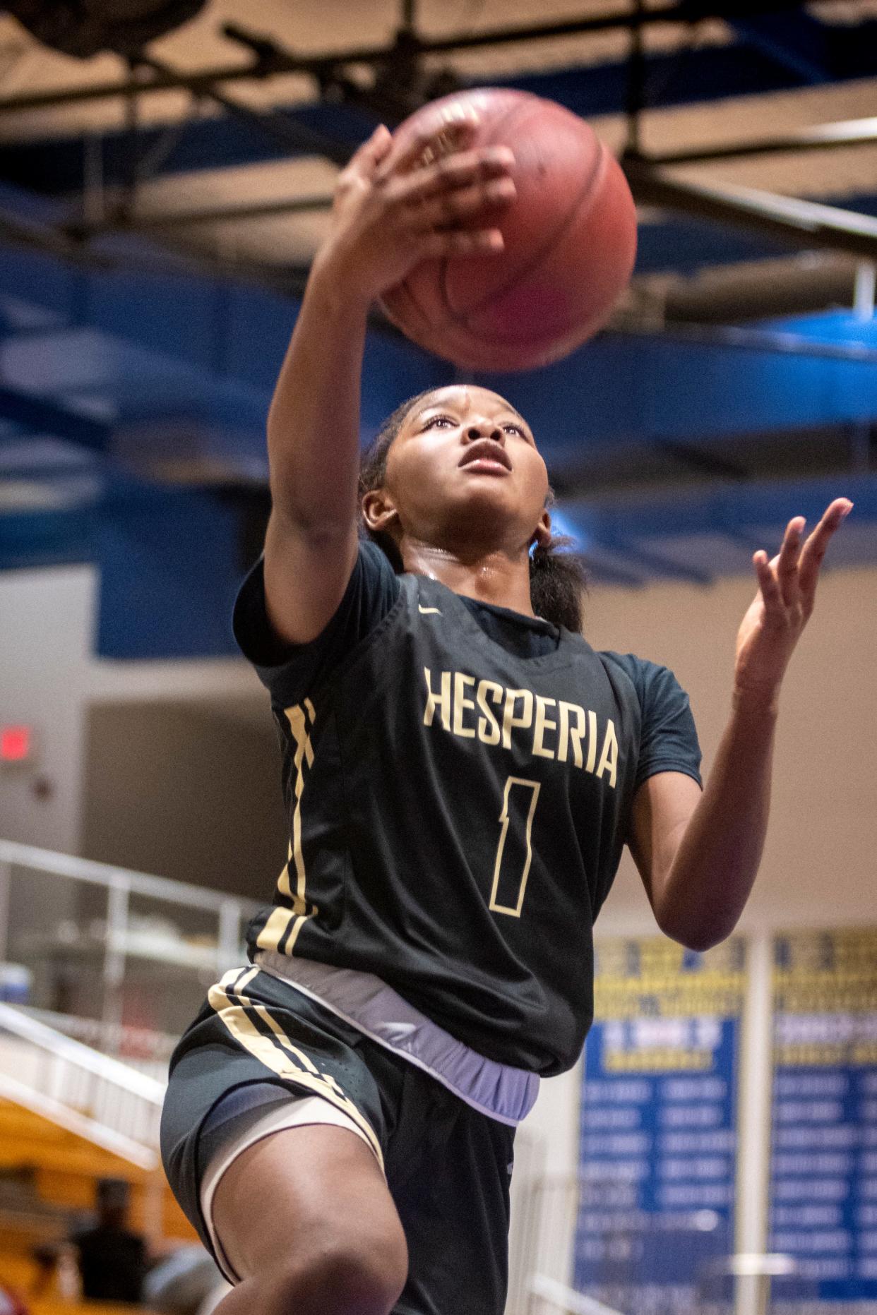 Hesperia's Queen Allah drives to the basket against Heritage during the championship game of the Serrano Holiday Classic in Phelan on Thursday, Dec. 30, 2021. The Scorpions won 72-20.